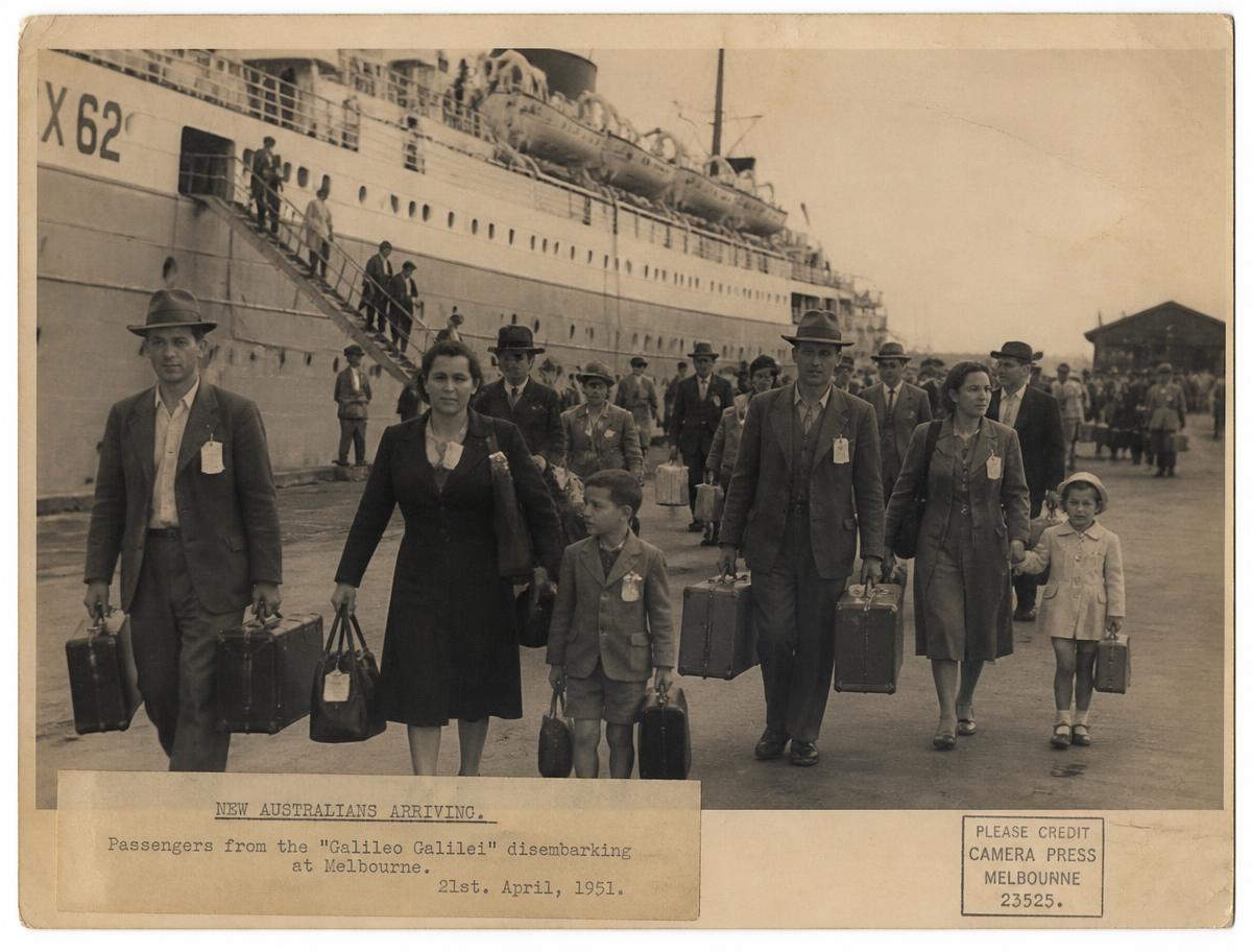 Migrant families disembarking an ocean liner at an Australian wharf in 1951